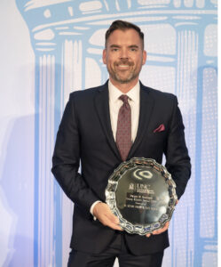 Adam Brown receiving award at UNC Kenan-Flagler business school