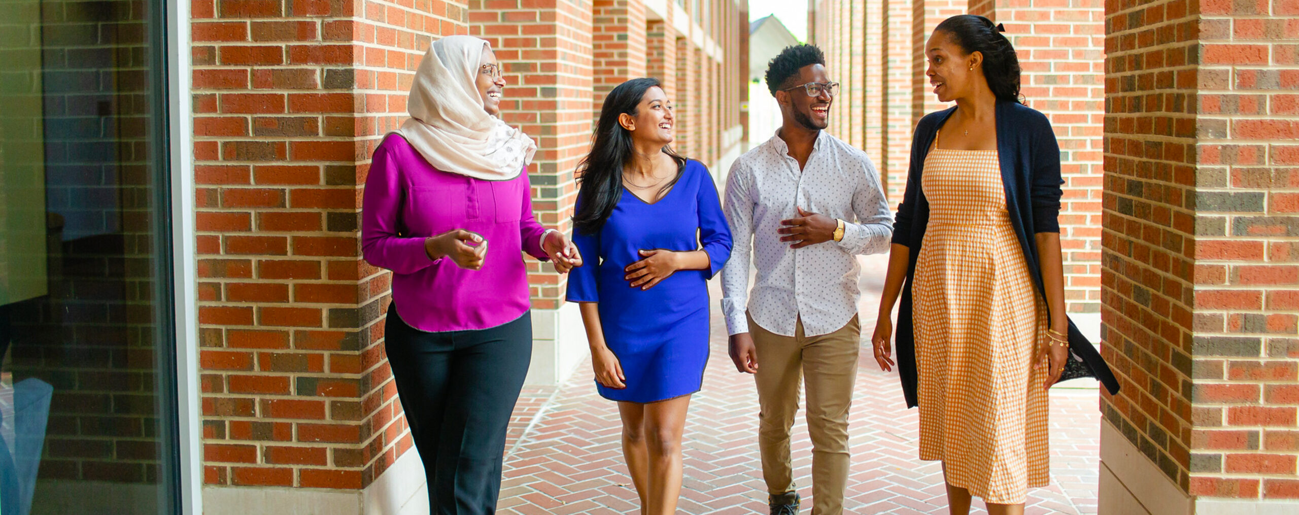 four students walking in front of McColl