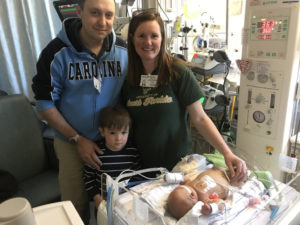 Scott, Debra and their oldest child Scott visit Michael at UNC Children’s Hospital.