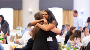 Ashraf Jaffer hugging student at UNC event