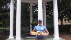 Alex Brandwein holding a tray of bagels