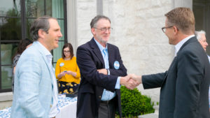 Durant Bell and UNC Kenan-Flagler Professor Dave Hartzell with Chancellor Kevin Guskiewicz