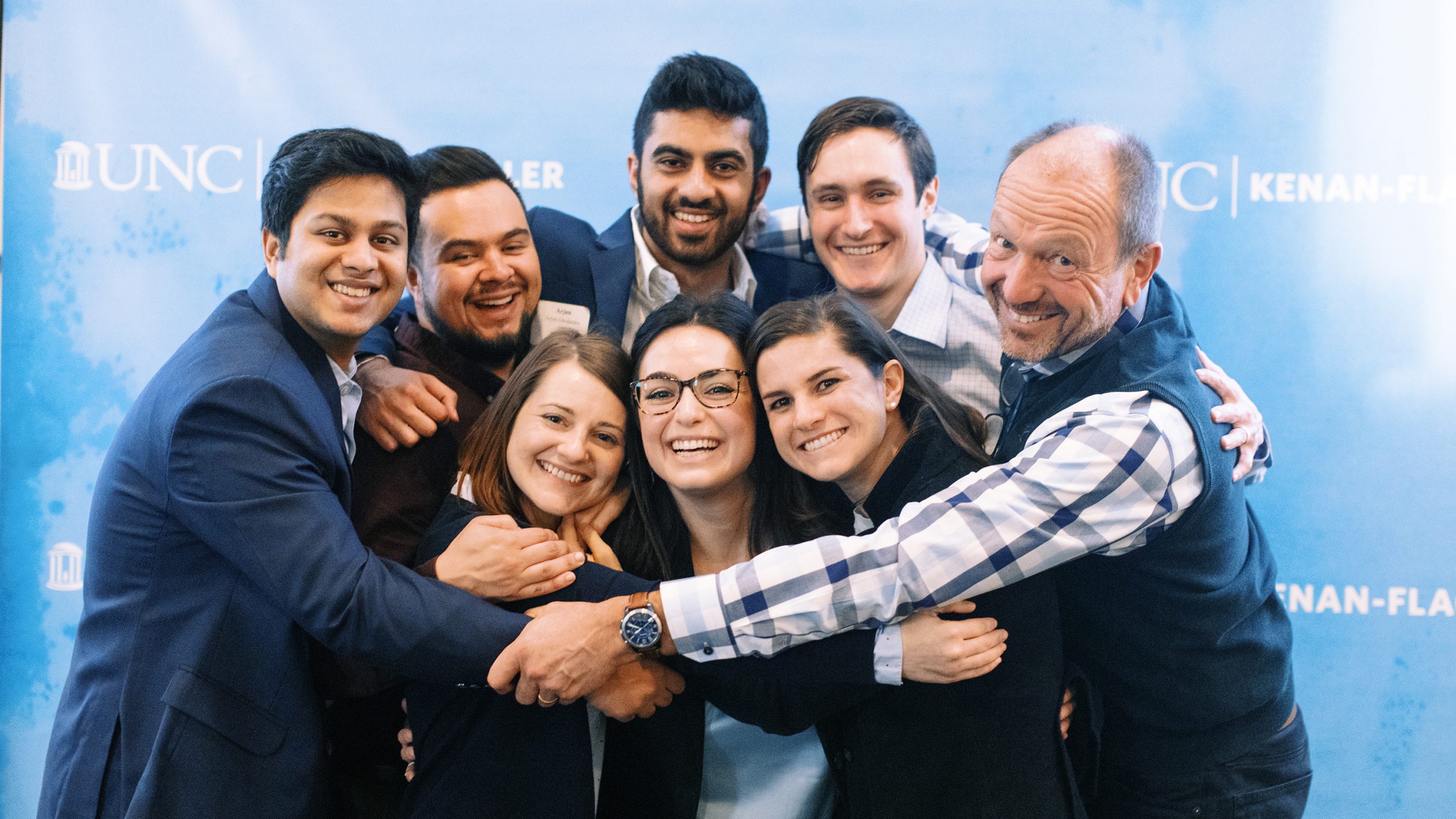 STAR students and faculty group hug at event