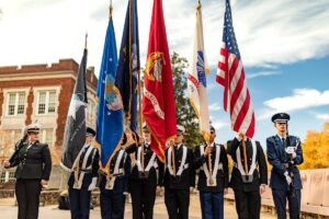 Veteran students of Kenan-Flagler holding flags