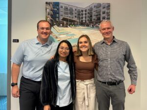 Portfolio Management Associate Zach Daughtry, Linh Tran, Carley Wiley, and Asset Management Director Mike Cox pose for a photo. 