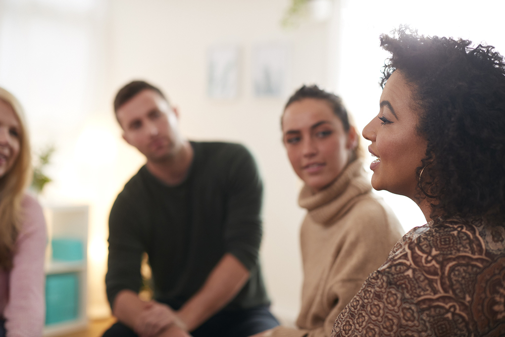 Woman Speaking At Meeting in Community Space