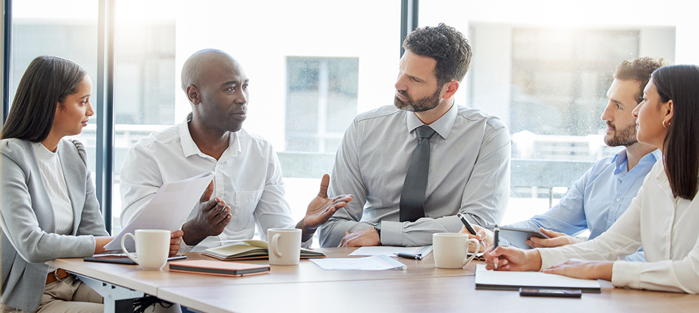 Group of businesspeople having a meeting in a boardroom at work