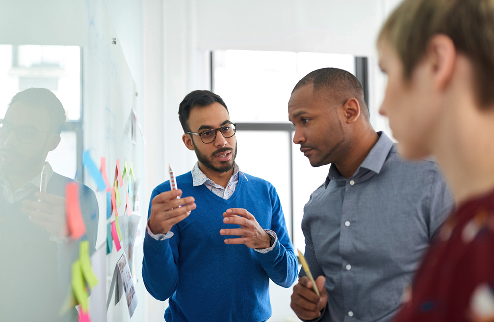 Businessman in a team of creative coworkers in a startup brainstorming strategies