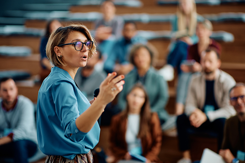 Female speaker giving a presentation during business seminar