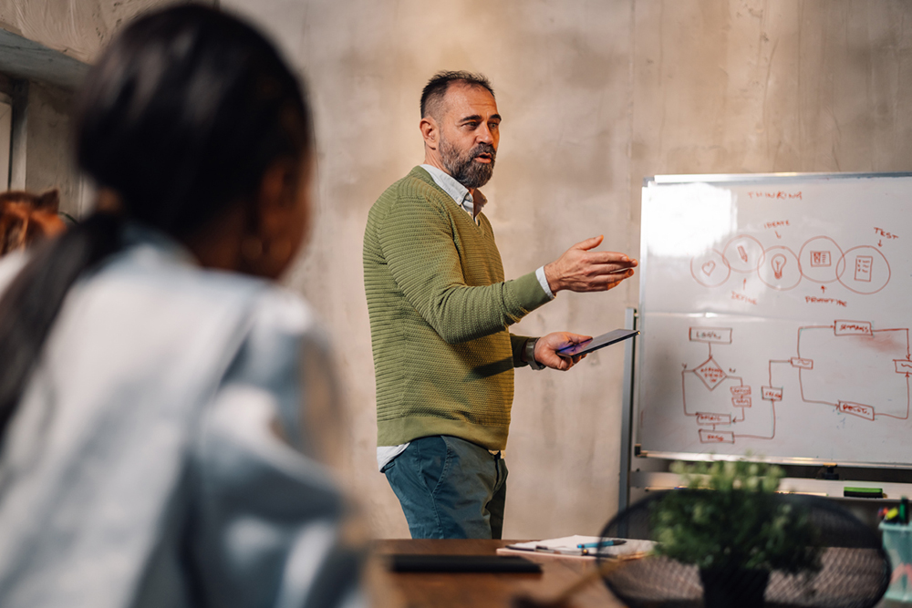 Businessman presenting business strategy to team.