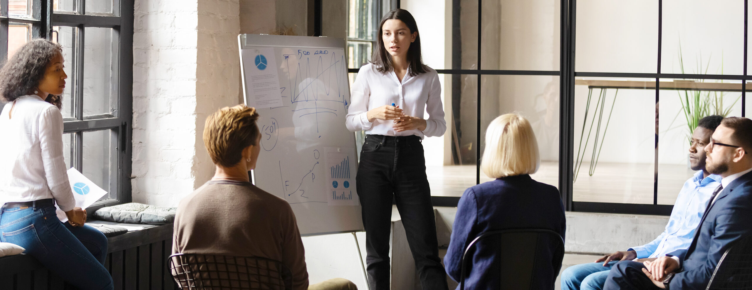 Woman presenting to an office meeting