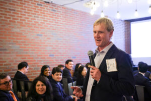 Jim Jones (MBA '16) addresses the crowd at the 2023 Alpha Challenge. 