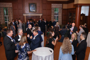 2025 Alumni Award attendees socialize around cocktail tables in the Kenan Center.