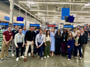 A group poses inside of a Walmart as a part of a recruiting trip.