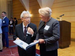 Barbara Stephenson presents Furuhata with a copy of "UNC Kenan-Flagler: A Century of Tradition and Innovation," which includes a story about his experience at Carolina. Photo by Yuuki Ide.