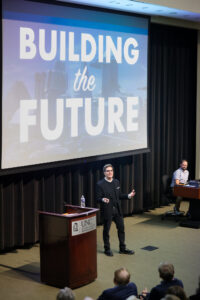 Jason Kilar (ABJM, BSBA ’93) speaks at the 2025 Weatherspoon Lecture in front of a slide that reads “Building the Future.”