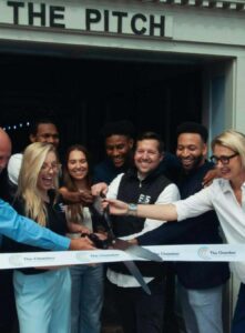 The EATS2SEATS team cuts a ribbon in front of The PITCH.