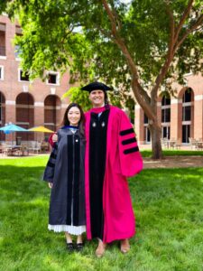 2)Blair Liu (PhD ’26) poses with Professor Brad Staats outside of McColl Building.