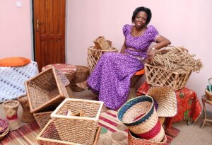 Achenyo Idachaba Obaro – MitiMeth sitting around a number of woven baskets