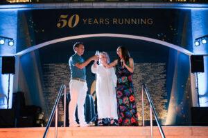 Joey Pointer (BSBA ’00, MAC ’01) celebrates 50 years of Fleet Feet with a toast.