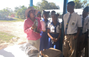 Carol Lue teaching students at a local high school about CaribShare
