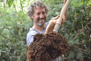 O’Hara displays fresh soil from The Ranch, which is vital for the local grown food and plants that keep life going in Mastatal. Via Rancho Mastatal