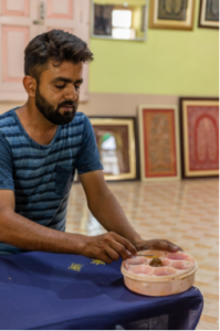 Artisan making Rogan Art.