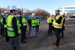 Real estate students in hard hats on a site