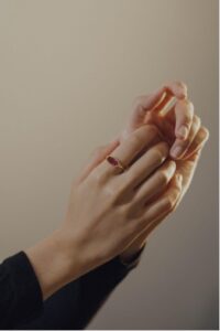 Two hands posing wearing Ataro rings.