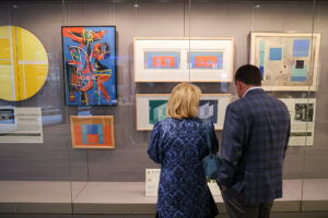 Two people look at The Johnson Collection.