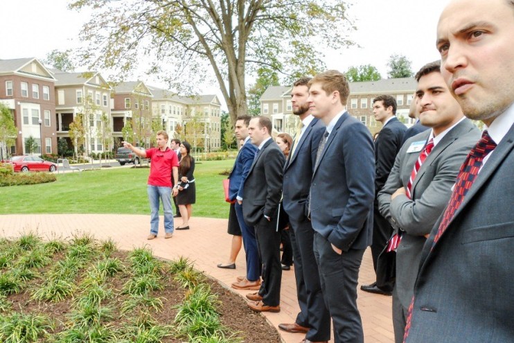 David Bookhout (MBA ’15), development manager with AvalonBay Communities, directs UNC Real Estate Club member’s attention to the extensive pet park and other site features meant to entice tenants at Avalon Falls Church.