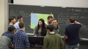 students standing together in a classroom