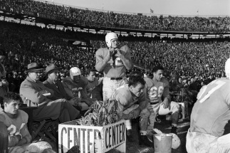 Paul Rizzo (No. 66) is shown with Coach Carl Snavely and Charlie 