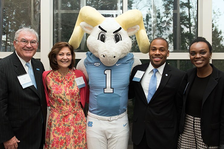 Students standing with the UNC mascot