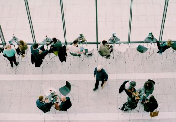 People Talking At Tables In Cafe