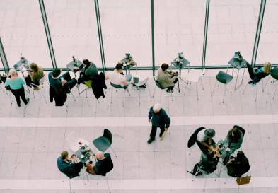 People Talking At Tables In Cafe
