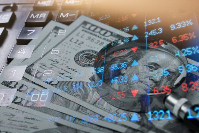 U.S. money and magnifying glass