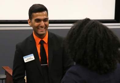 Jay Patel talking to a woman, both in business attire