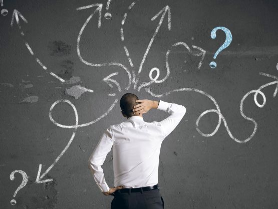 Man in front of chalk board