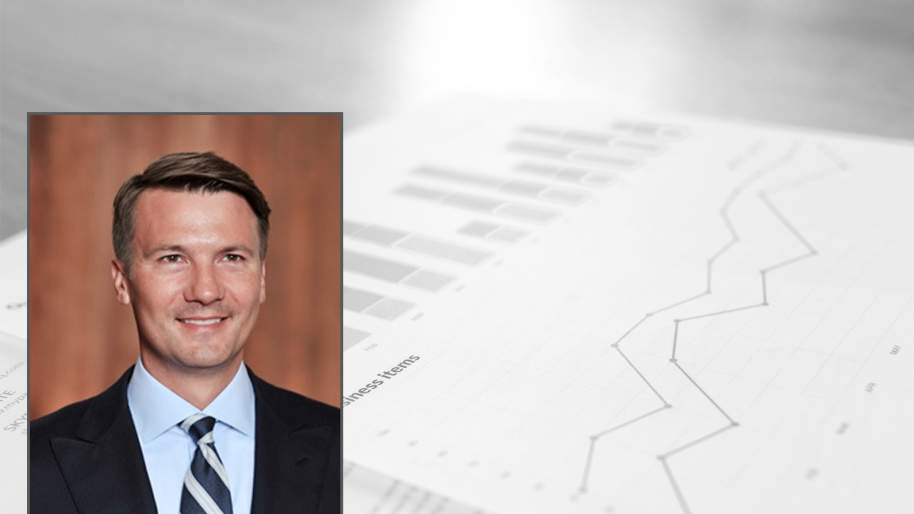 Nathan Andrews headshot with charts in background