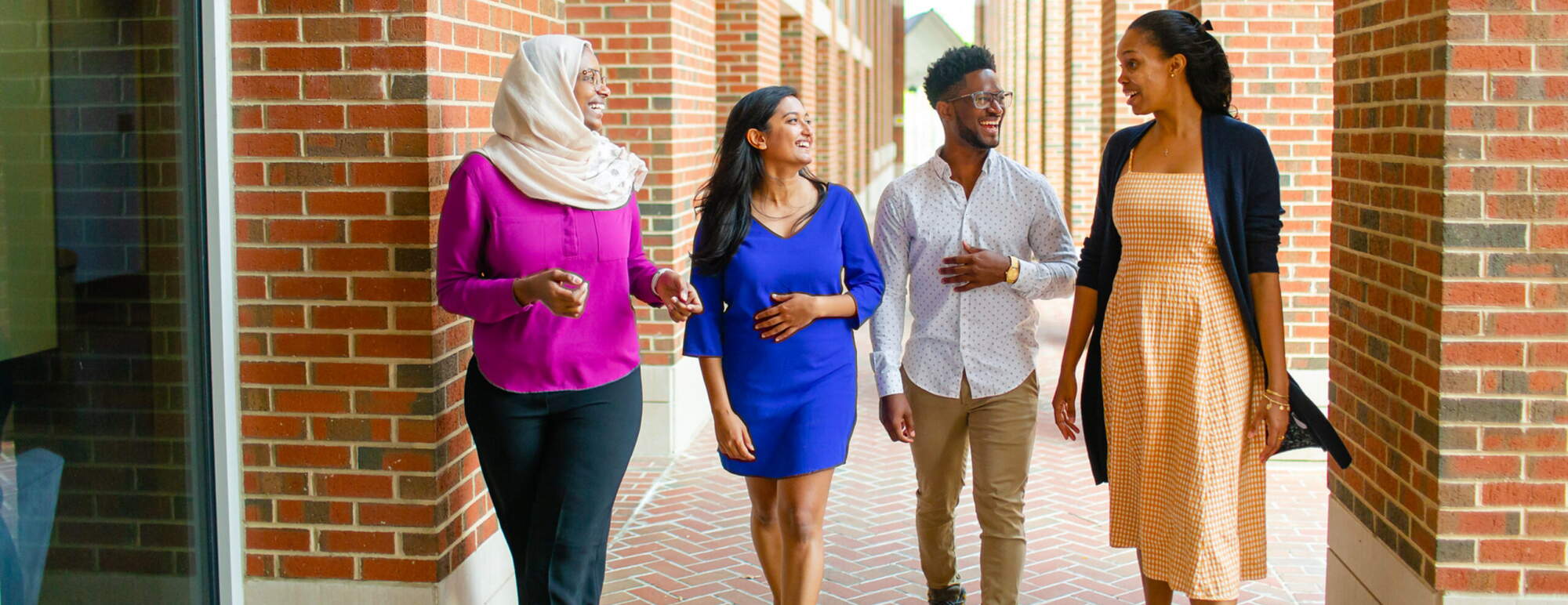 four students walking in front of McColl