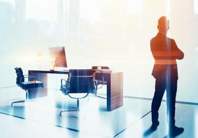 man standing in office by desk