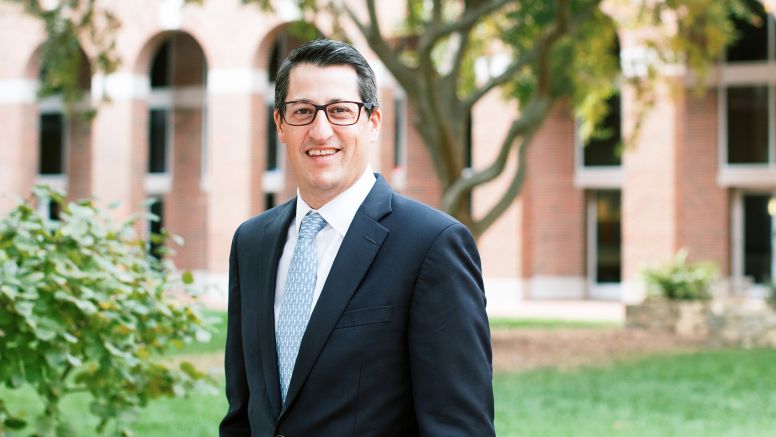 Matt Mitcho stands in front of UNC Kenan Flagler McColl building