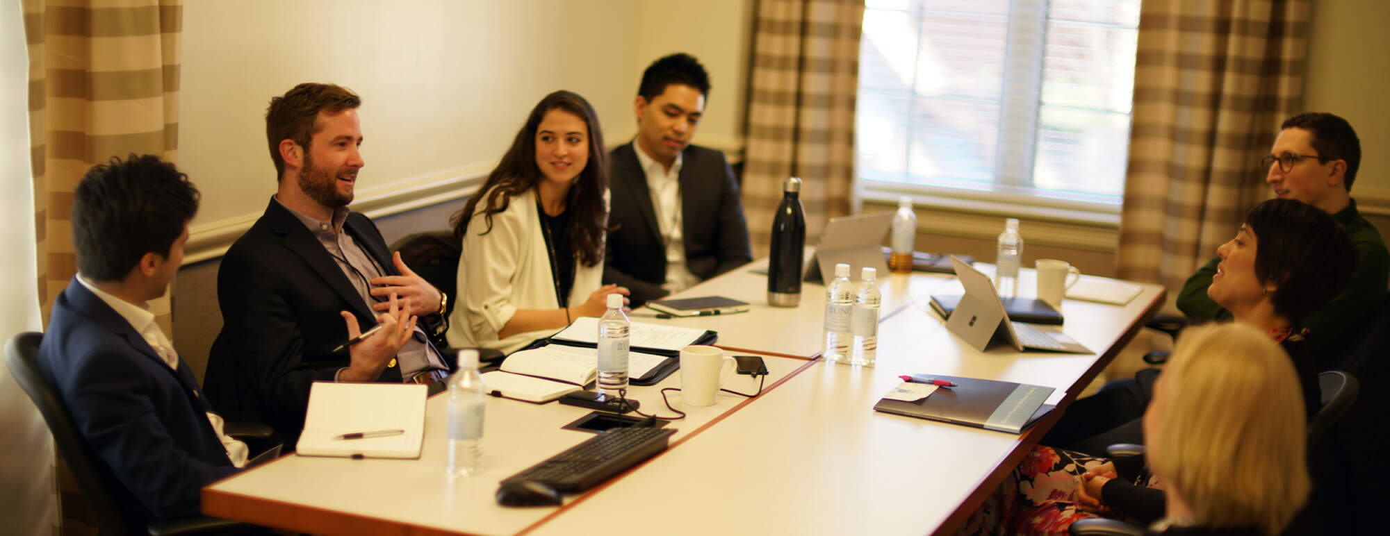 S.T.A.R. student participants sit around a conference table in conversation