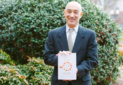 William Putsis holding his new book The Carrot And The Stick Book at UNC Kenan-Flagler