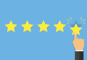 Hovering hand places fifth gold star on blue background