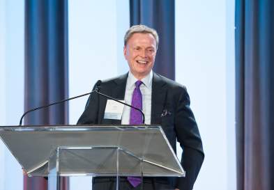 Steve Cumbie Speaking At Podium