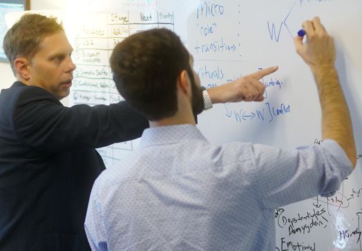 PhD students at whiteboard