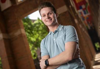 Kenan-Flagler campus background with Graeme Strickland smiling
