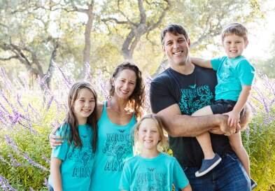 Kate Welbourn and family smiling wearing wade army shirt